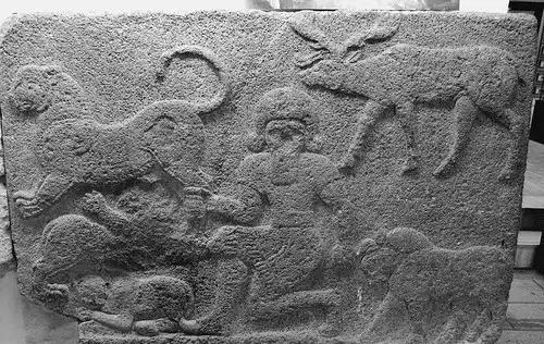 Hittites: Master of animals (Gilgamesh) grasps the hind leg of a lion in one hand, the horn of a bull in the other and is accompanied by a stag and two other beasts, Mythological scene, The Herald Wall’s reliefs, Carchemish by Efendi.